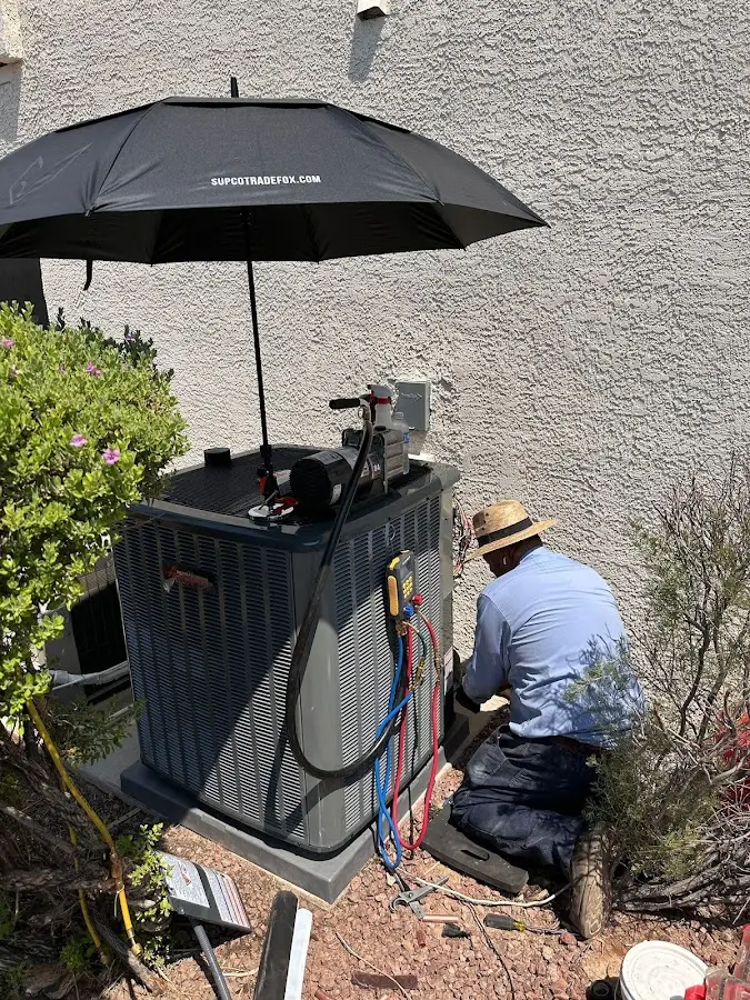 HVAC technician performing outdoor AC maintenance in Bridgeport